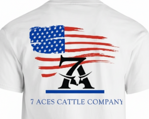White short-sleeve t-shirt showing the back graphic with a distressed American flag, a black stylized '7' and 'A' logo, and the text '7 ACES CATTLE COMPANY' in blue.